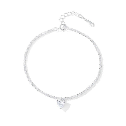 Silver bracelet with a heart-shaped charm on a white background.