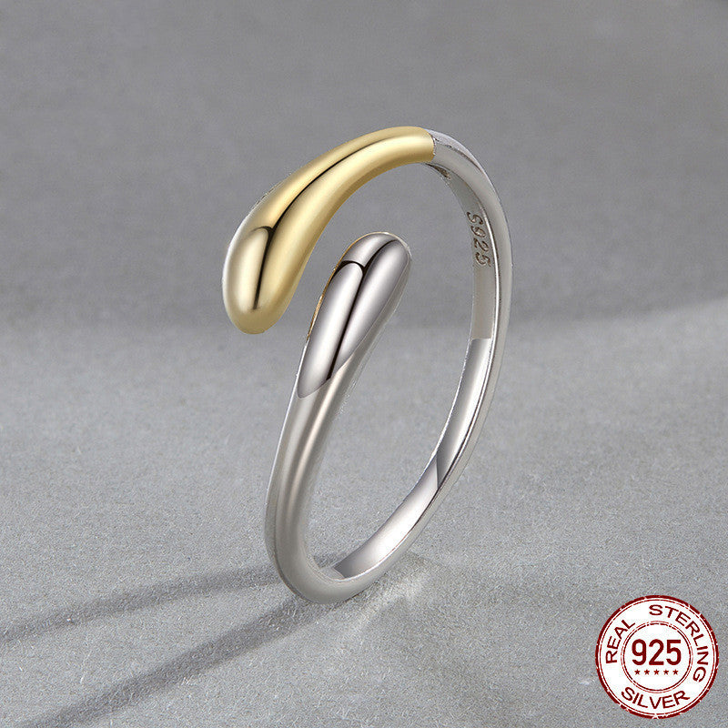 Two-tone gold and silver ring on a gray background with 'Real Sterling Silver 925' stamp.