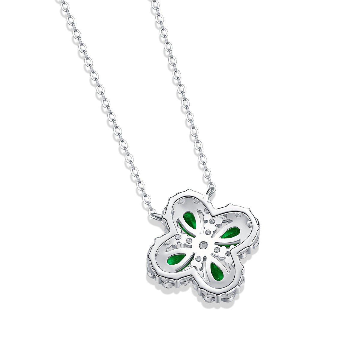 Silver necklace with a flower-shaped pendant featuring green stones on a white background showing back of the pendant.