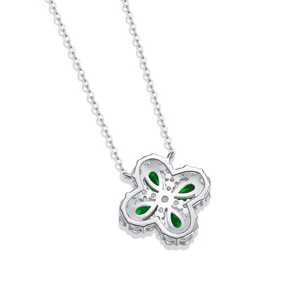 Silver necklace with a flower-shaped pendant featuring green stones on a white background showing back of the pendant.