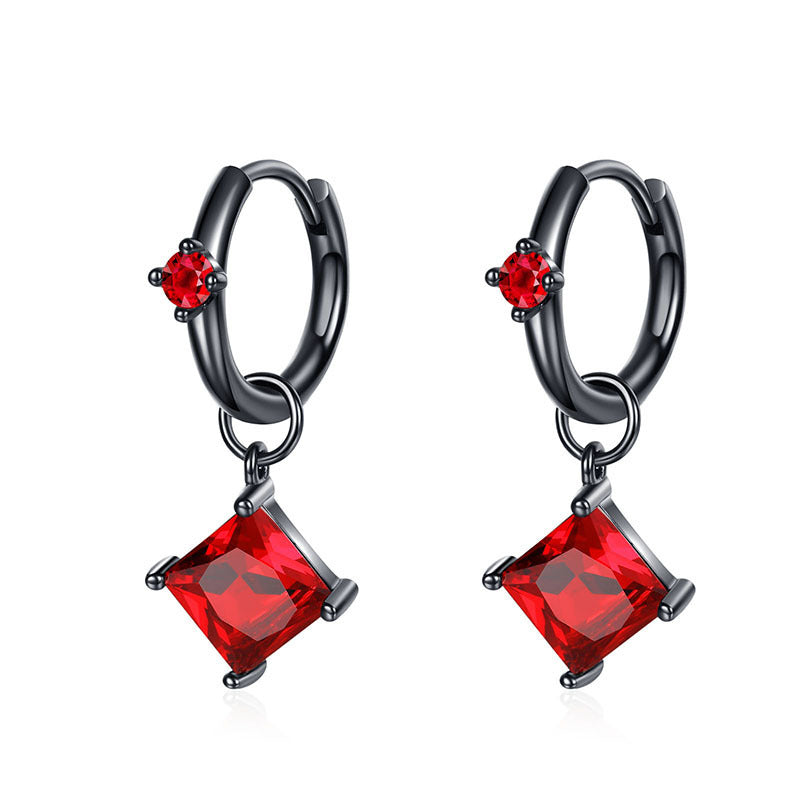Pair of hoop earrings with red gemstones on a white background