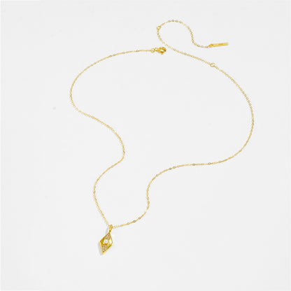 Gold color necklace with a pendant on a white background.